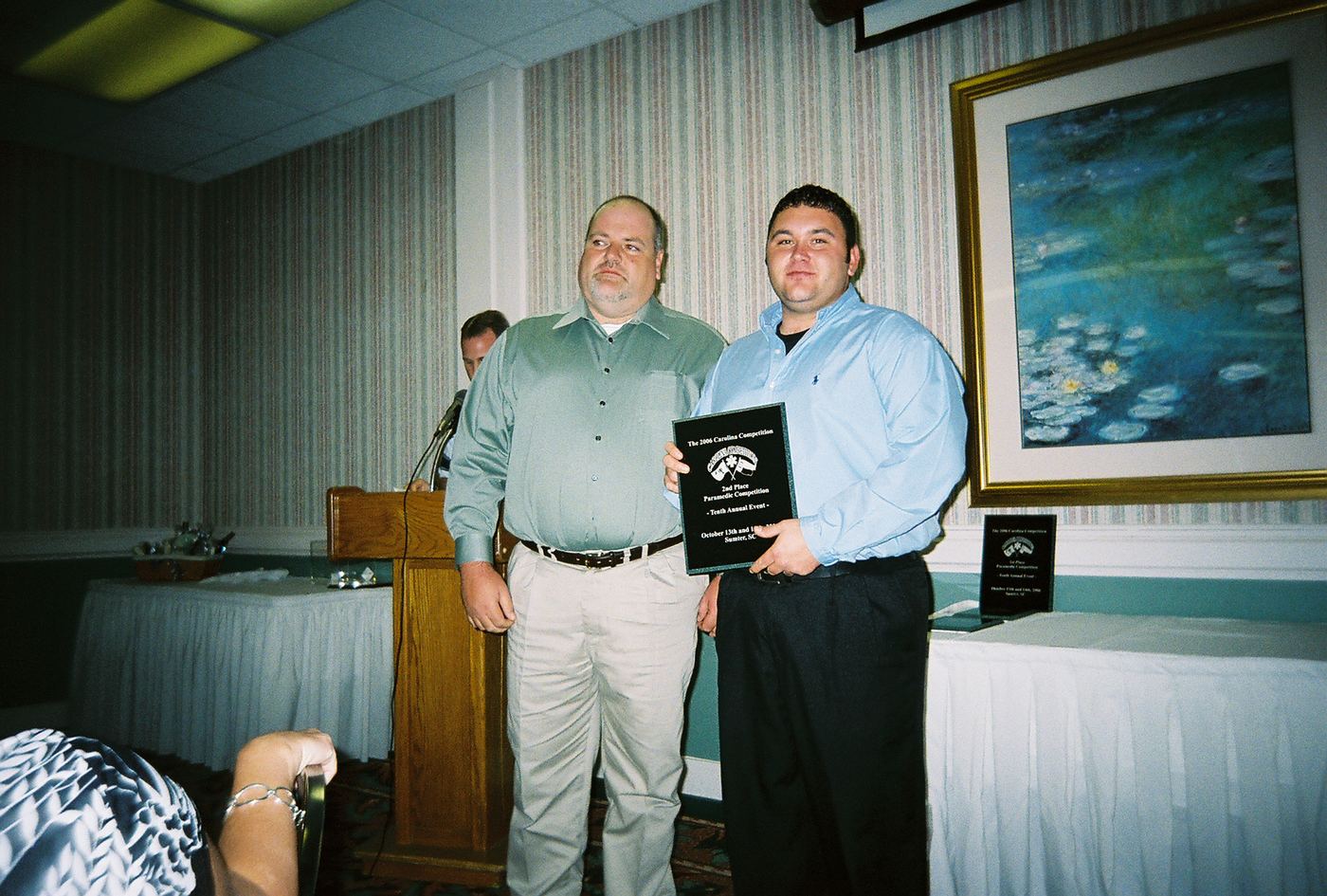 Two men holding a second-place plaque at the 2006 banquet in Sumter