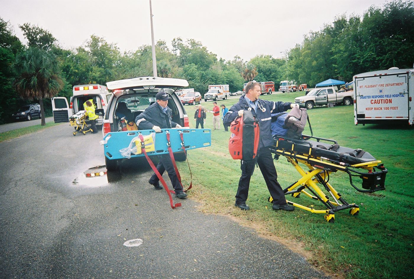 Two medics carrying a backboard away from an open ambulance in Charleston, 2008