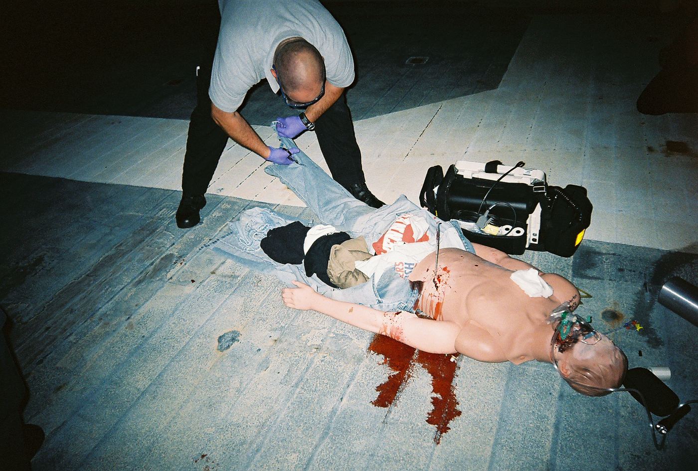 A medic cutting clothing from a manikin during a night scenario in Charleston, 2008