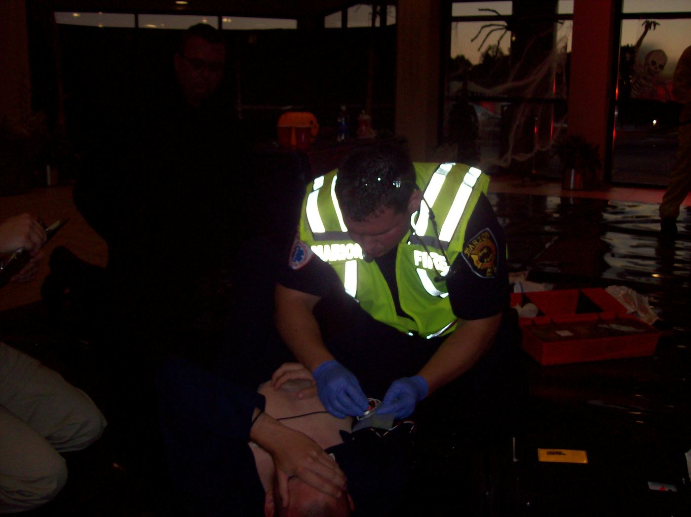 A medic working a patient during a dark indoor scenario in Florence, 2010